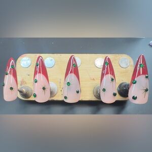 Burgundy French tips with hand, painted gold starbursts & emerald gems